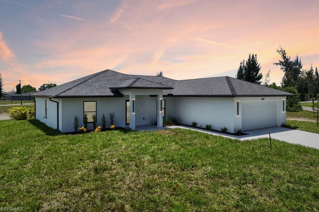 Contemporary single-story residence with a dark shingle roof and stucco exterior