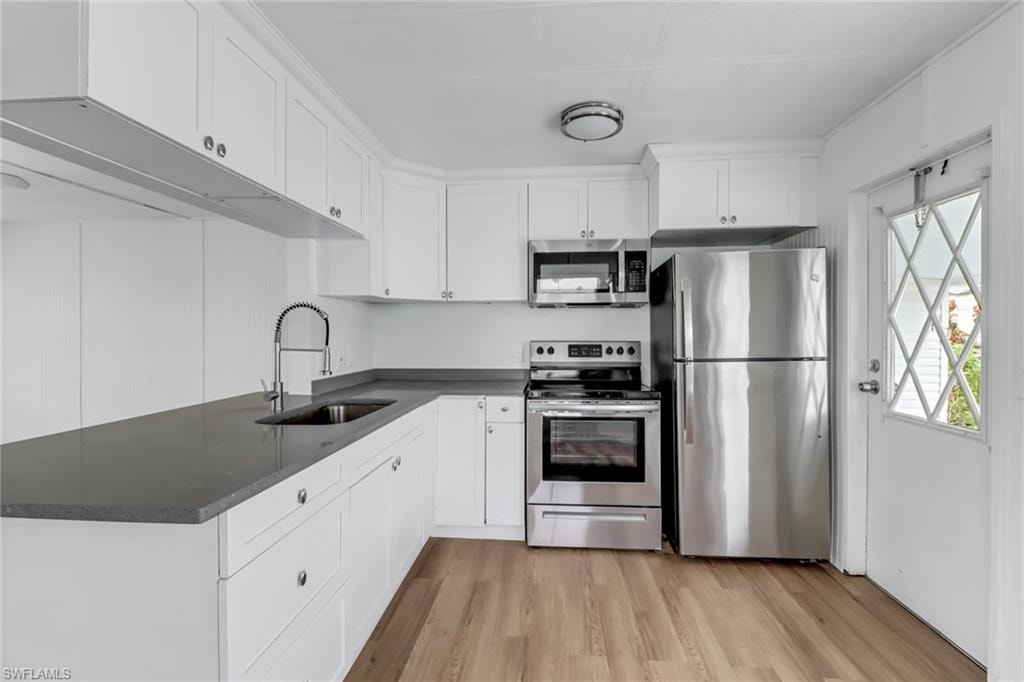 Bright Kitchen with Stainless Steel Appliances & White Shaker Cabinets