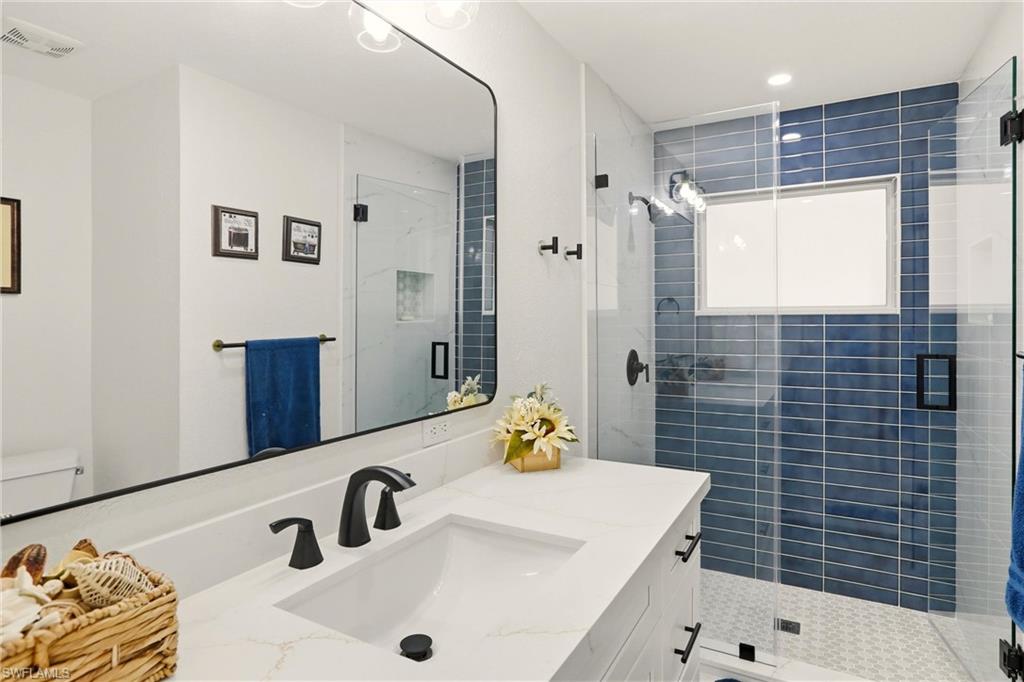Full bath with vanity and a stall shower