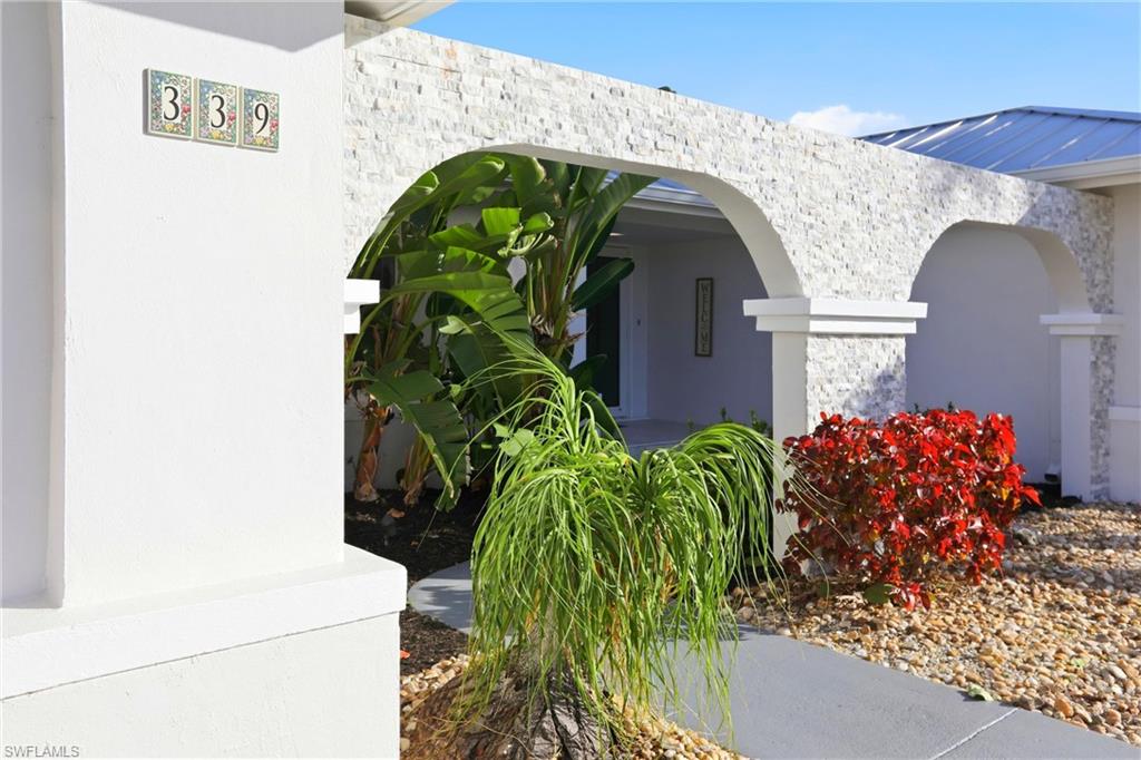 Property entrance featuring stone siding and stucco siding