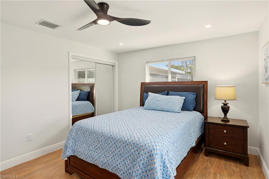 Bedroom featuring a closet, ceiling fan, light wood-style floors, and recessed lighting