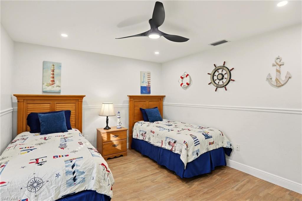 Bedroom featuring wood finished floors, recessed lighting, and a ceiling fan