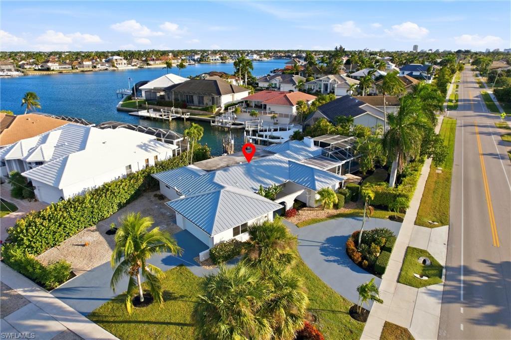 Aerial view of residential area featuring a nearby body of water