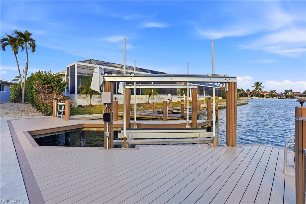Dock area with boat lift and a water view