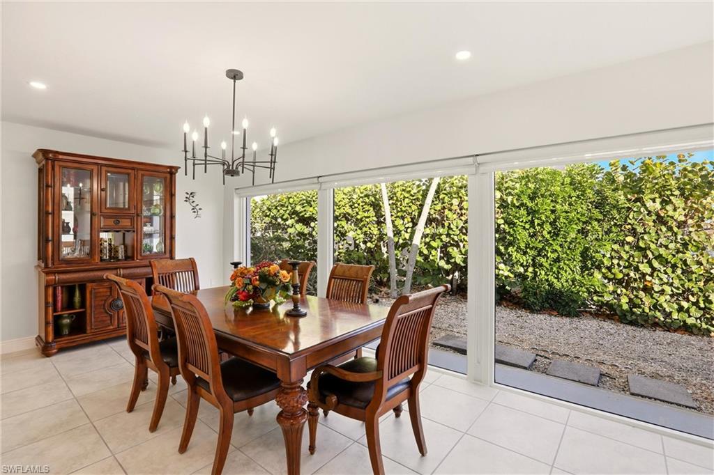 Dining room featuring recessed lighting, light tile patterned floors, and a chandelier