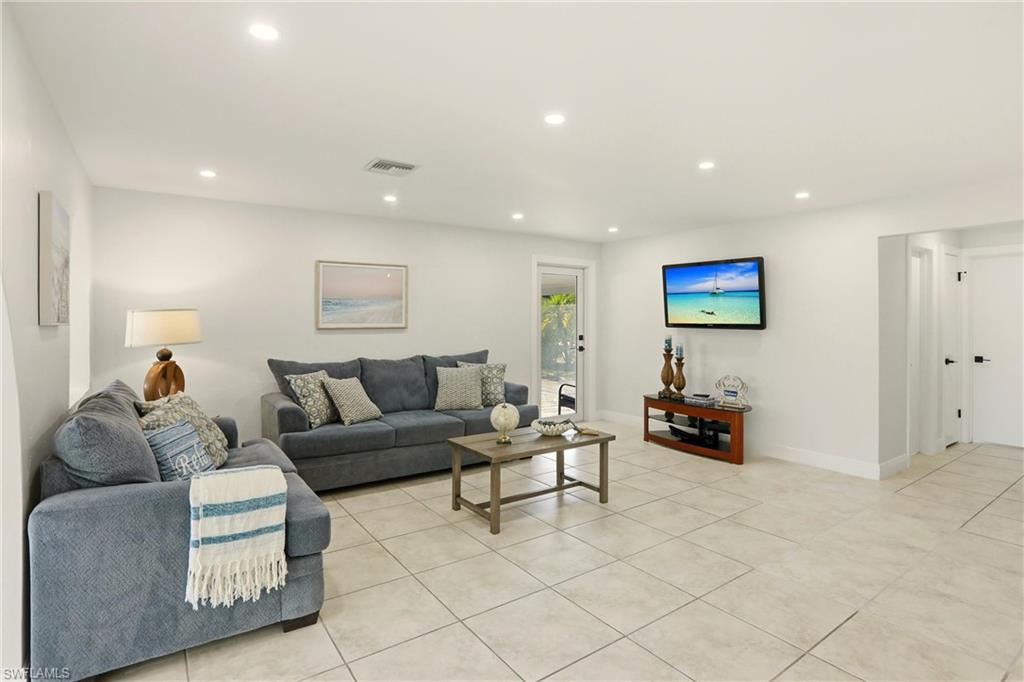 Living room featuring recessed lighting and light tile patterned flooring