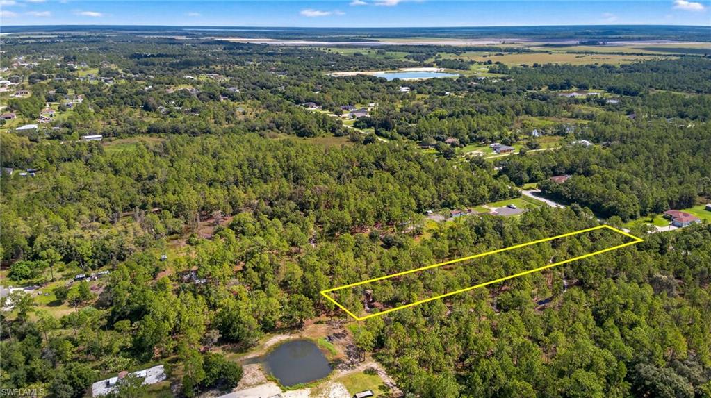 Aerial view of property's location featuring property parcel outlined and a nearby body of water
