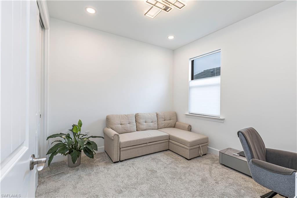 Carpeted office with recessed lighting and baseboards