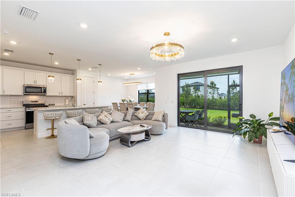 Living area featuring a chandelier, recessed lighting, and light tile patterned floors