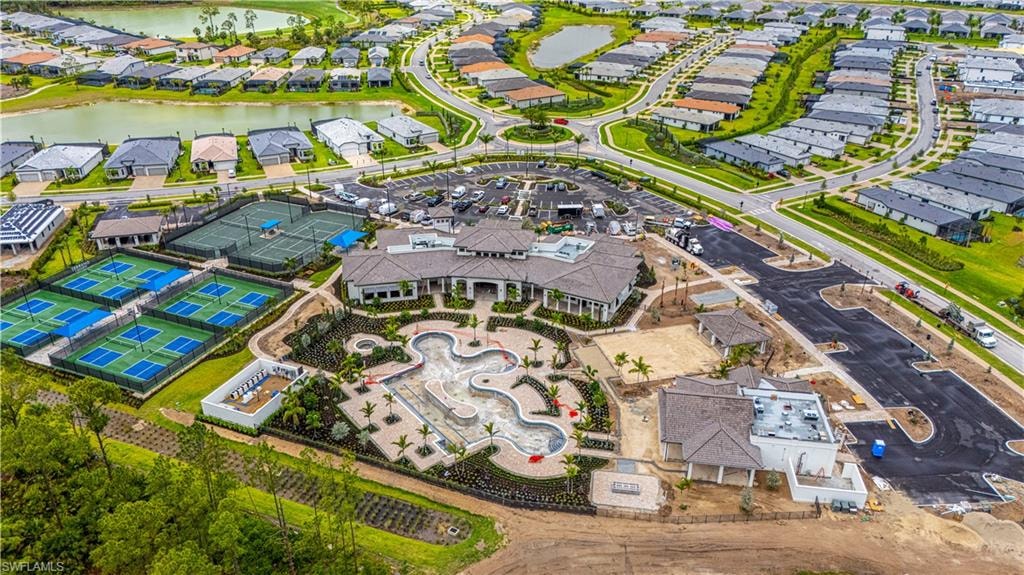 Aerial view of property's location featuring a large body of water and nearby suburban area