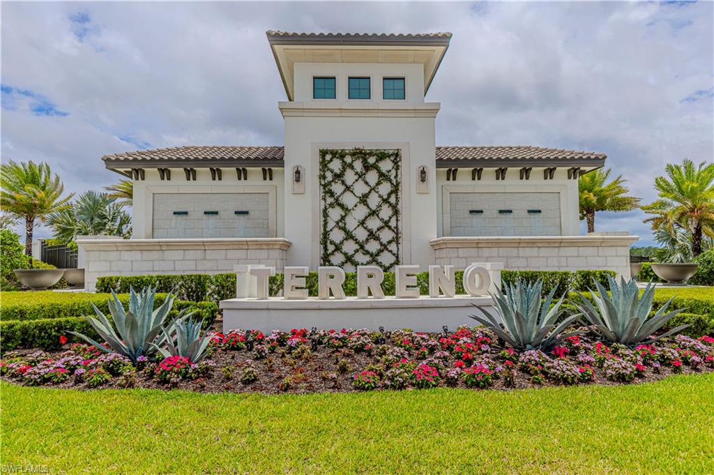 View of front of property with a tiled roof, stucco siding, and a front yard