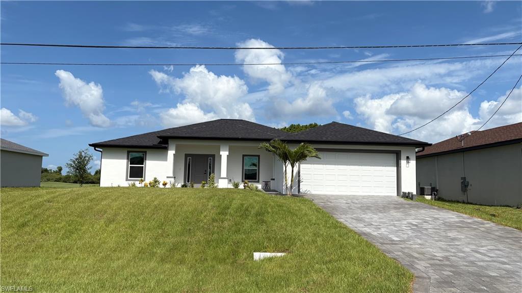 Contemporary single-story residence featuring a white stucco exterior and a dark shingle roof