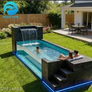 Contemporary above-ground pool with a glass side panel, integrated waterfall feature, and an attached wood-finish deck with steps