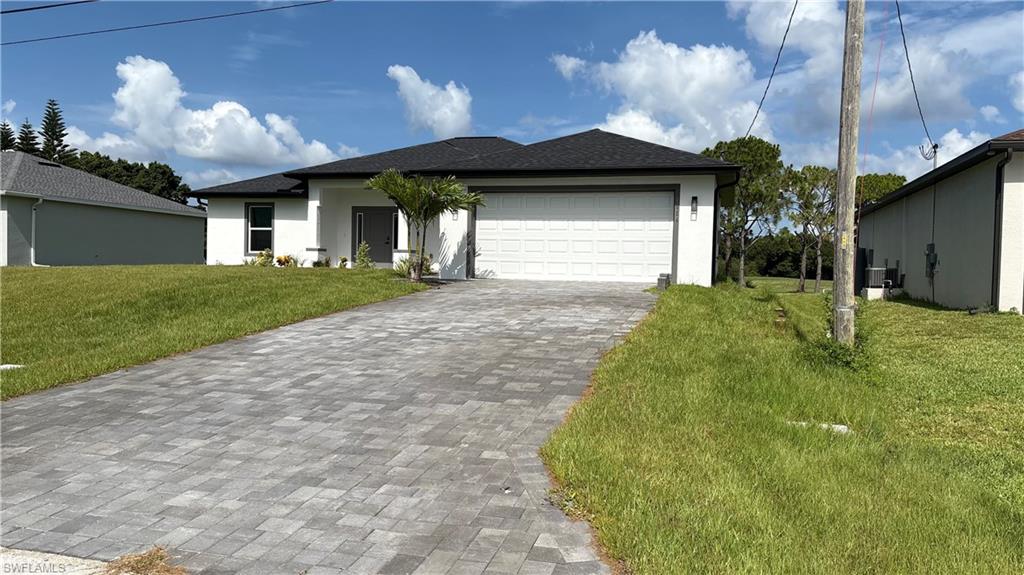 Contemporary single-story residence with a dark shingle roof and white stucco exterior