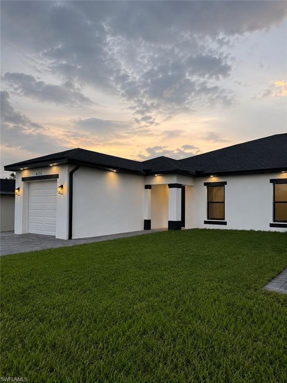 Modern single-story residence with a white exterior and contrasting black trim