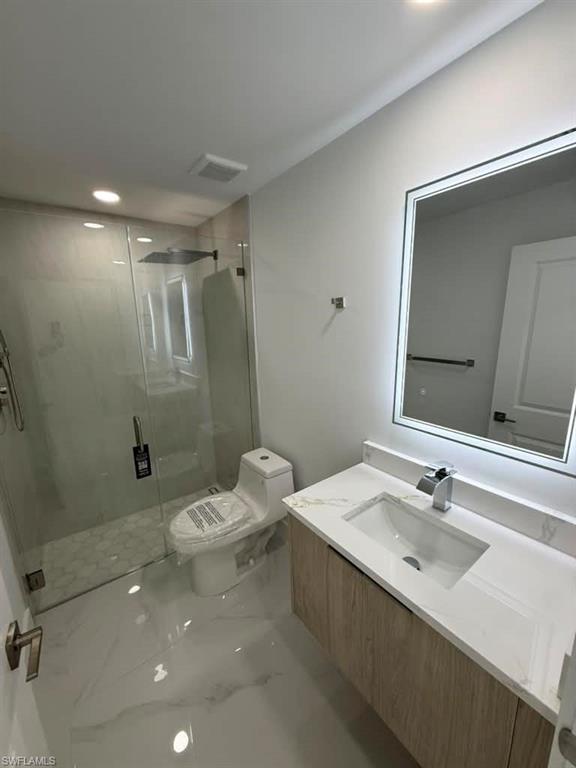 Modern bathroom featuring a floating vanity with a white countertop and integrated sink
