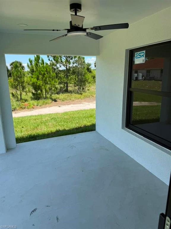 Covered patio featuring a ceiling fan with integrated lighting, recessed lighting, and a painted concrete surface