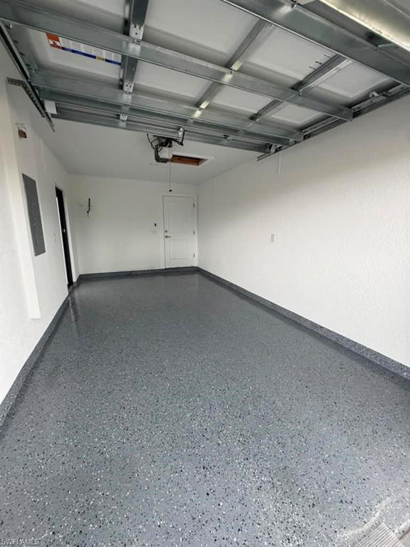 Spacious garage featuring a durable, speckled epoxy floor finish