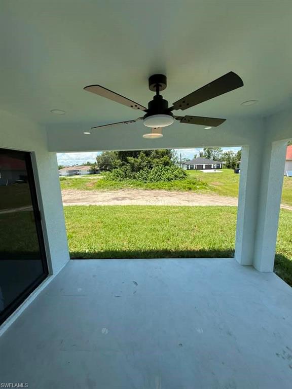 Covered patio featuring a black ceiling fan with integrated lighting, recessed ceiling lights, and painted concrete flooring