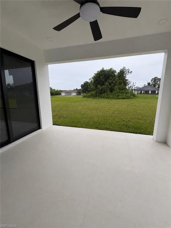 Covered patio featuring large formablob:https://web.whatsapp.com/d4a93732-53ad-4200-b1fb-37279b68ef2at light-toned tile flooring, a contemporary ceiling fan with integrated lighting, and recessed ceiling lighting