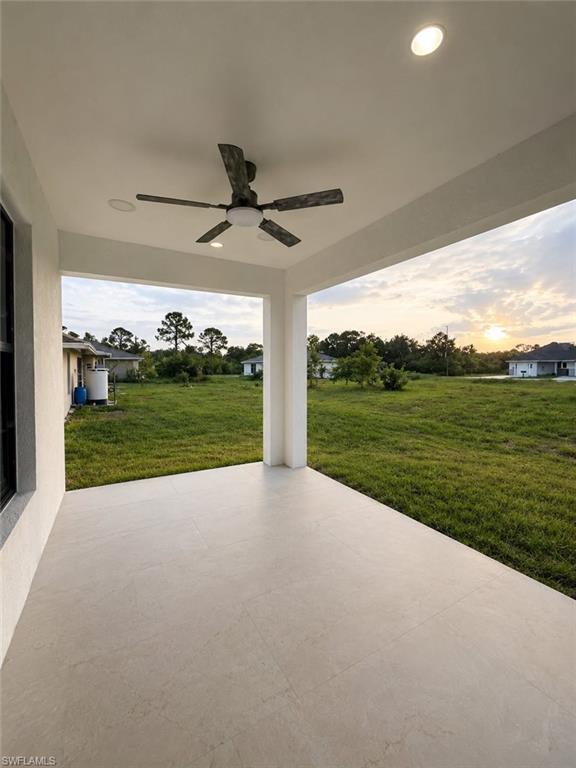 Covered patio featuring large format tile flooring, recessed lighting, and a ceiling fan