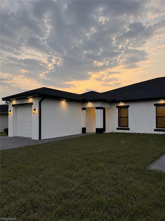 Contemporary single-story residence with a white stucco exterior and dark trim