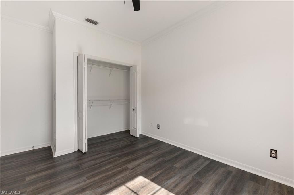 Interior space featuring wood-finish flooring, white baseboards, and white walls