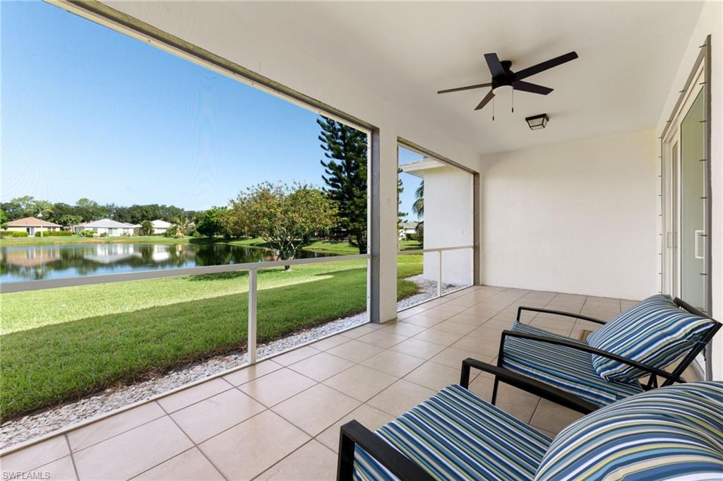 Screened lanai featuring large format tile flooring and a ceiling fan
