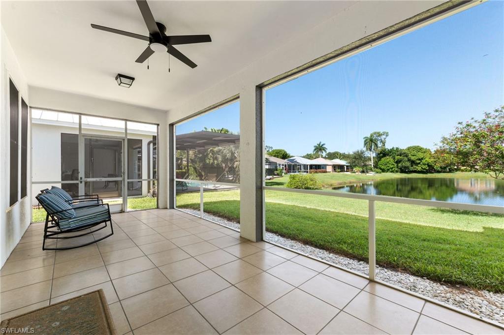 Screened patio featuring tile flooring and a ceiling fan