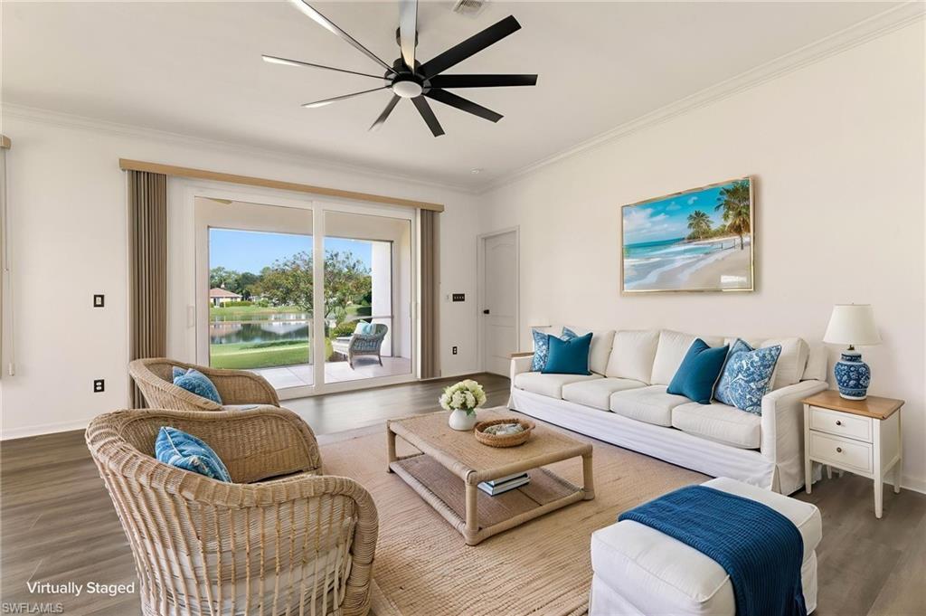 Spacious interior with wood-finish flooring and a contemporary ceiling fan