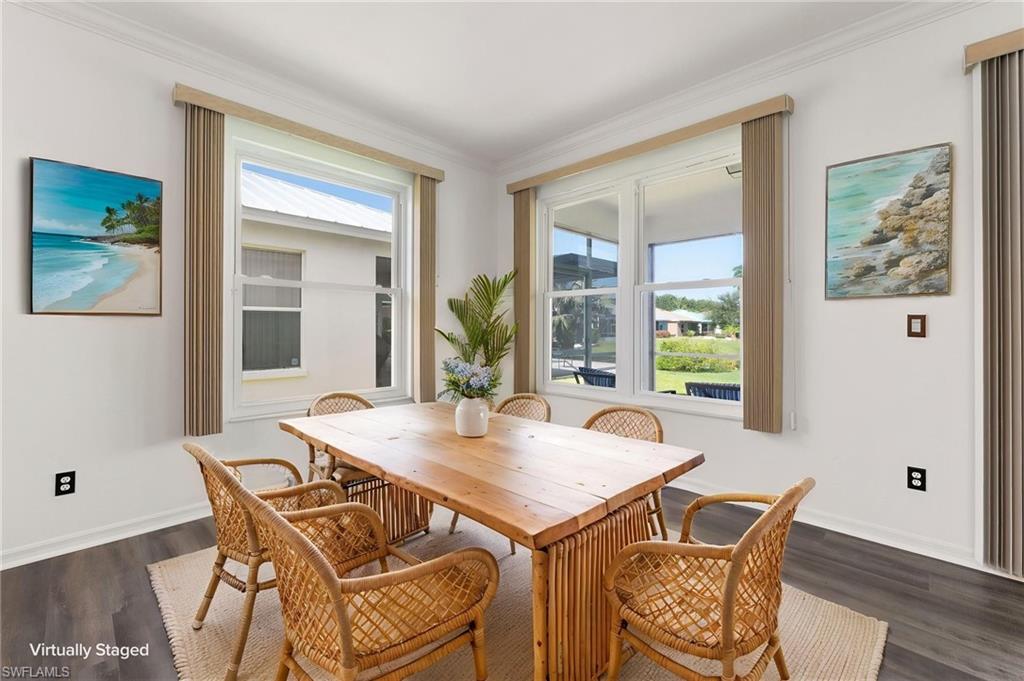 Dining area featuring multiple double-hung windows with vertical blinds