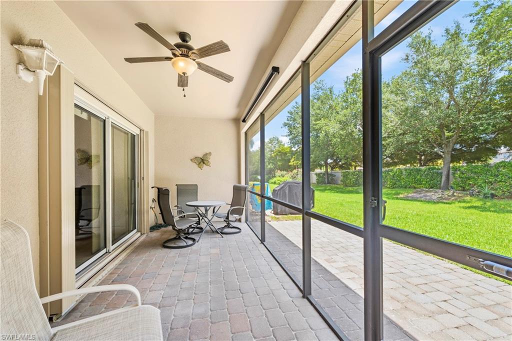 Screened lanai featuring a paver patio and ceiling fan with integrated lighting