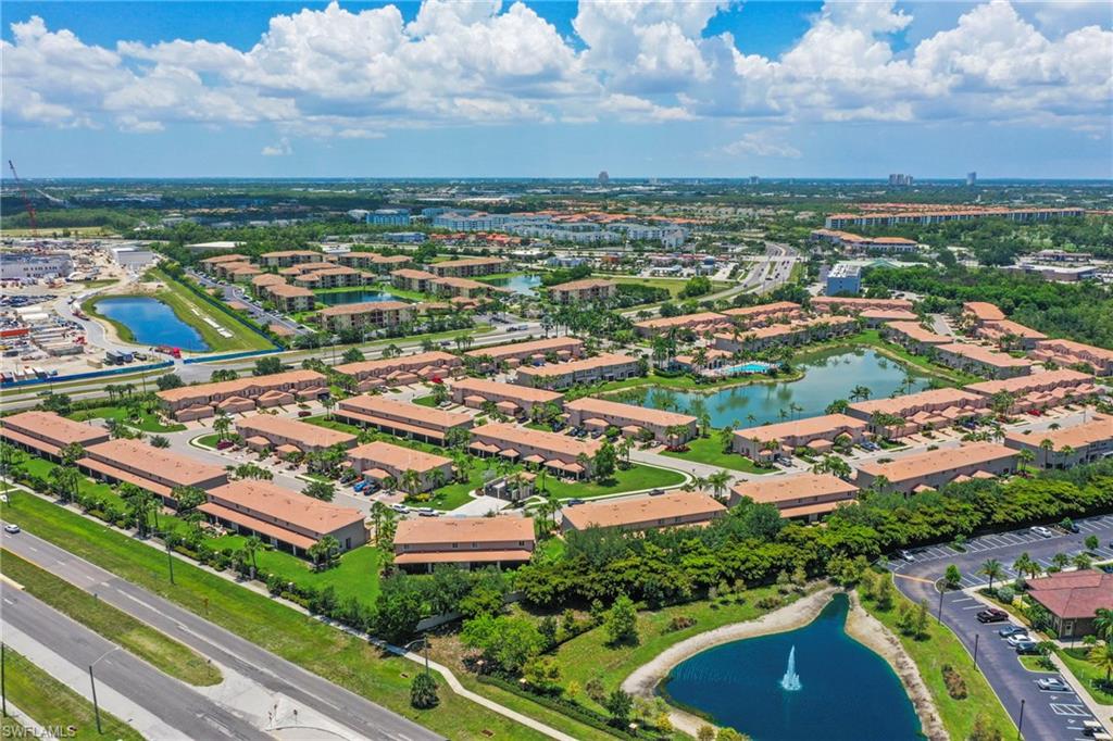 Expansive community with numerous buildings featuring terracotta-style roofs and light-colored stucco exteriors