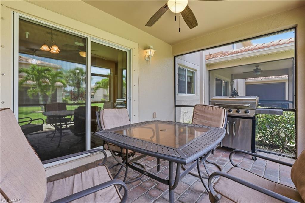 Screened patio with paver flooring, overhead ceiling fan, and direct exterior access via sliding glass doors