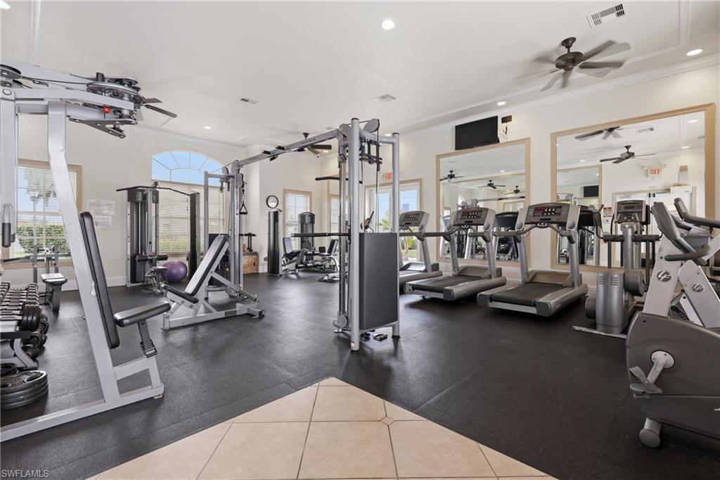 Spacious fitness center featuring  with ceiling fans, recessed lighting, and large mirrors