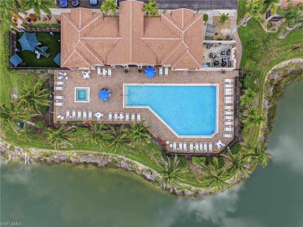 Community recreation area featuring a large swimming pool, integrated spa, and expansive paver deck