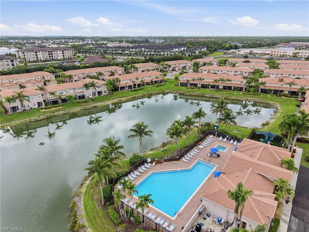 Community pool area featuring a large swimming pool, separate spa, and surrounding lounge seating