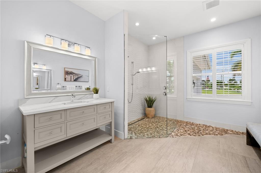 Primary bath with custom tile and glass wet room