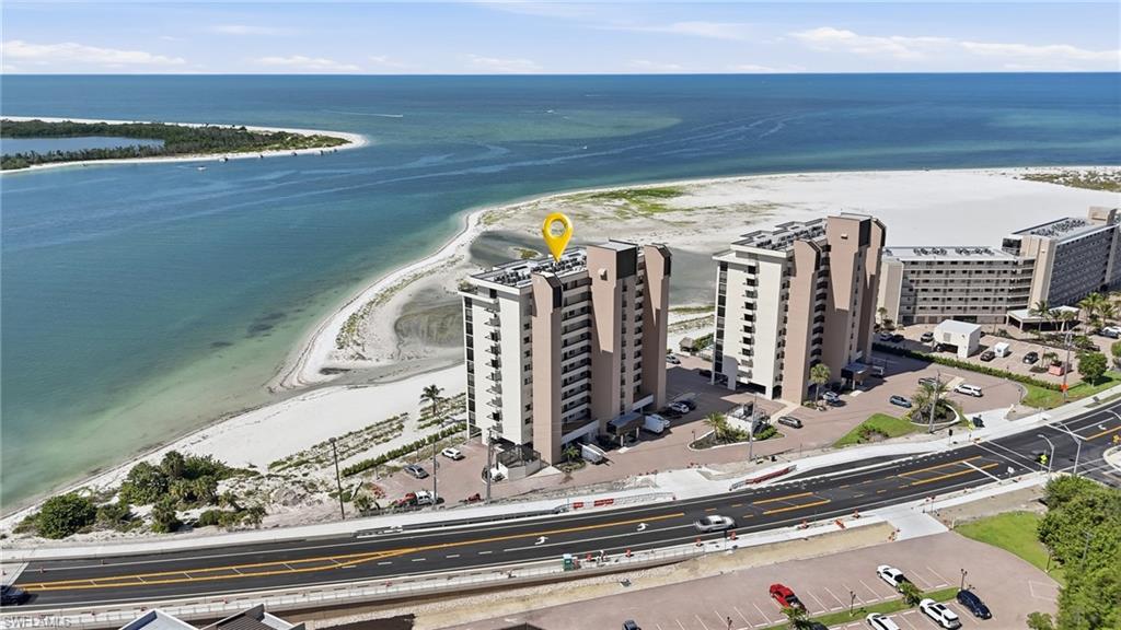 Aerial perspective showcasing multi-story residential buildings situated along a coastline - Virtually Edited Image