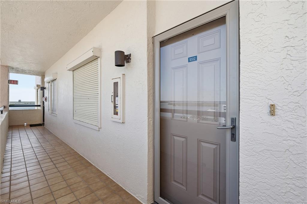 Entrance door with integrated security screen and polished hardware - Virtually Edited Image