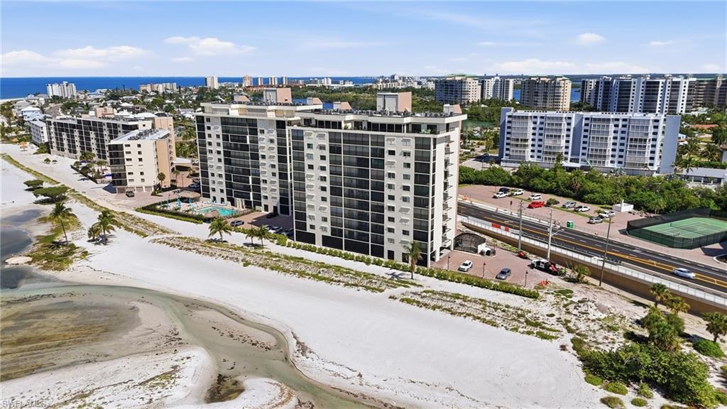Beachfront condominium complex featuring multiple stories and private balconies - Virtually Edited Image