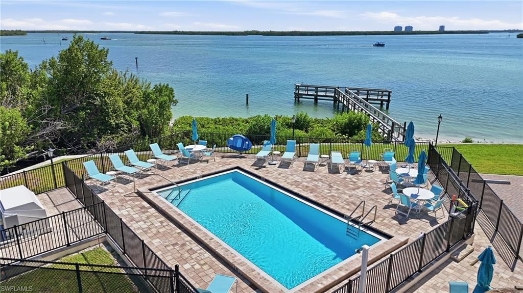 Fenced rectangular swimming pool surrounded by a paver patio - Virtually Edited Image