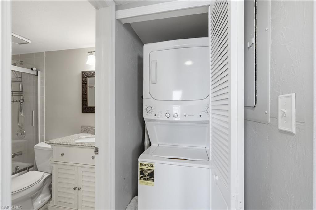 In-unit stackable washer and dryer, discretely housed within a louvered bi-fold door closet - Virtually Edited Image