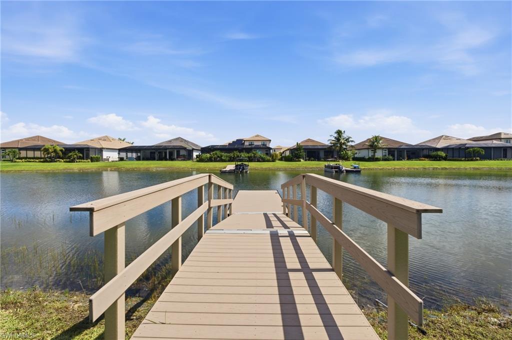 Private dock extending over a body of water with a manicured shoreline