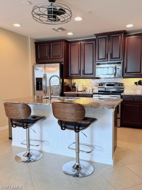 Fully equipped kitchen with granite countertops, modern appliances, and a breakfast bar.