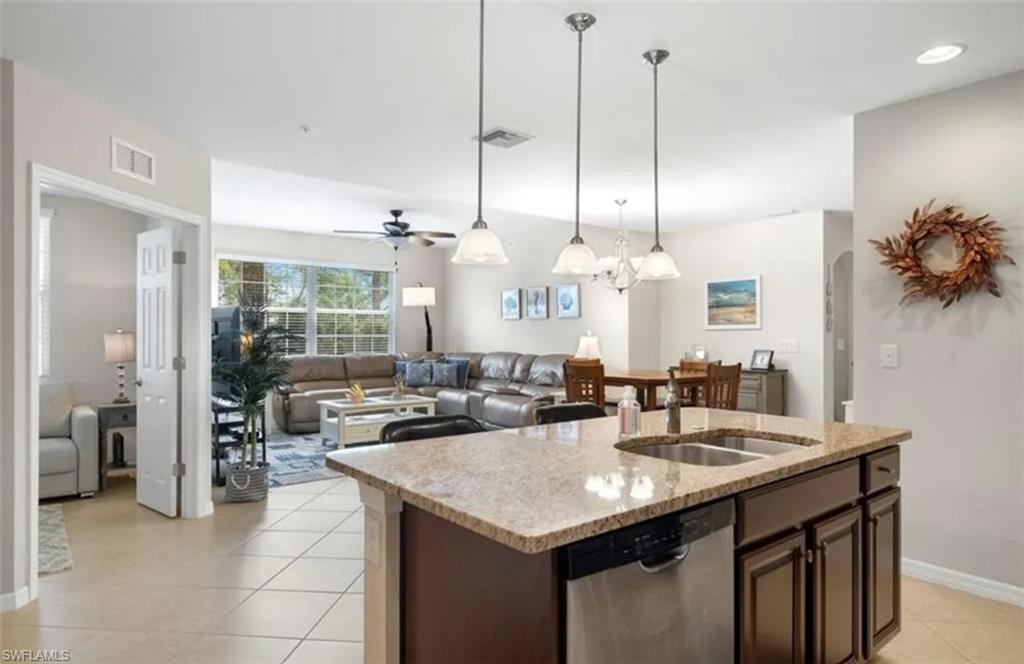 Open-concept great room where the gourmet kitchen flows into the living space.