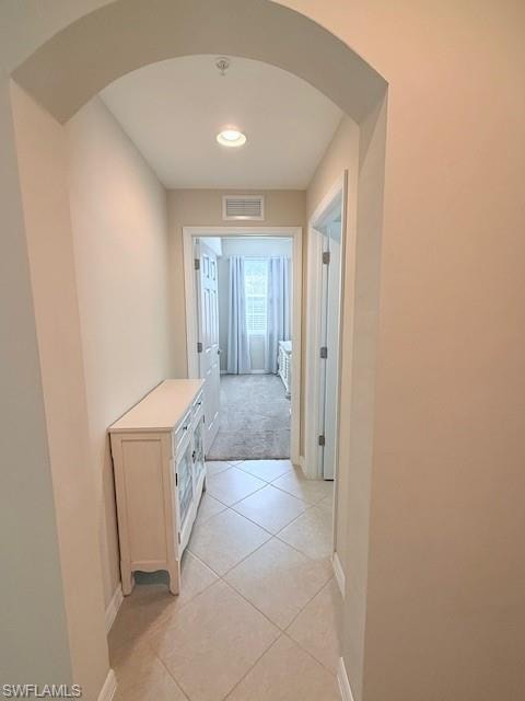 Bedroom hallway with storage and natural light.