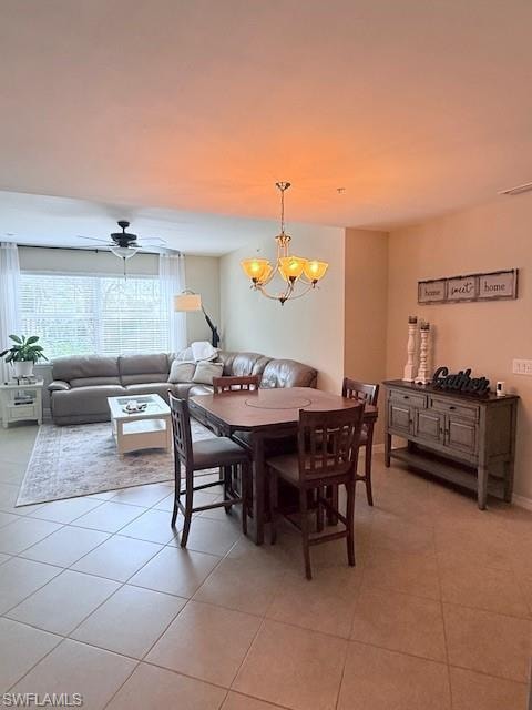 Open-concept living and dining area with chandelier lighting and comfortable seating.