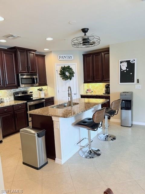 Fully equipped kitchen with granite countertops, stainless modern appliances, and a breakfast bar.