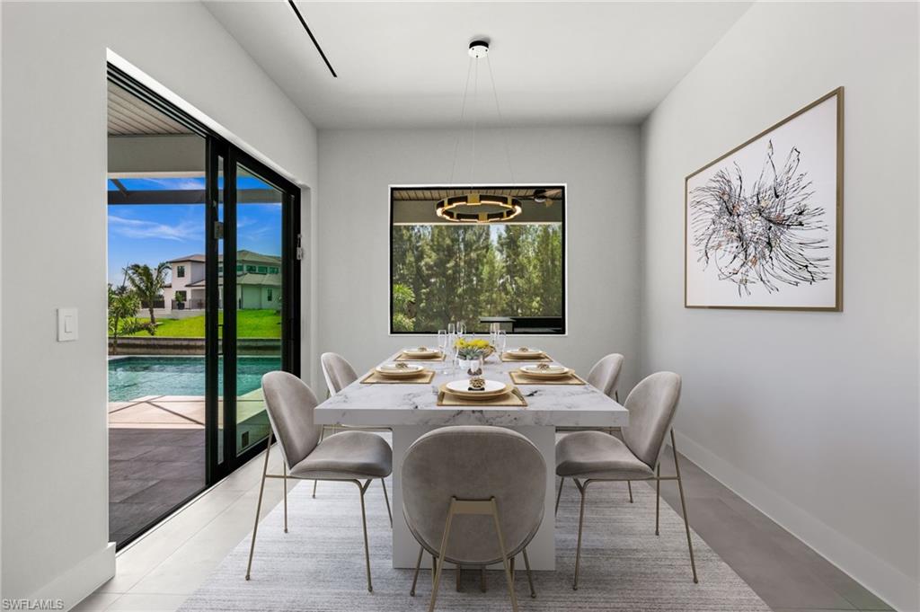 Dining area featuring a marble-finish table and contemporary chandelier